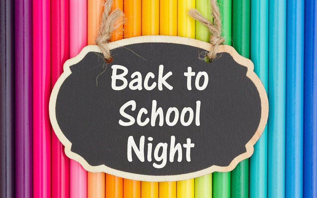 back to school night sign in front of rainbow of colored pencils