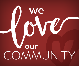 we love our community words on red background