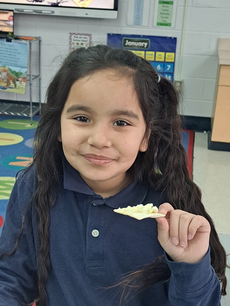 Student holding a cracker with butter