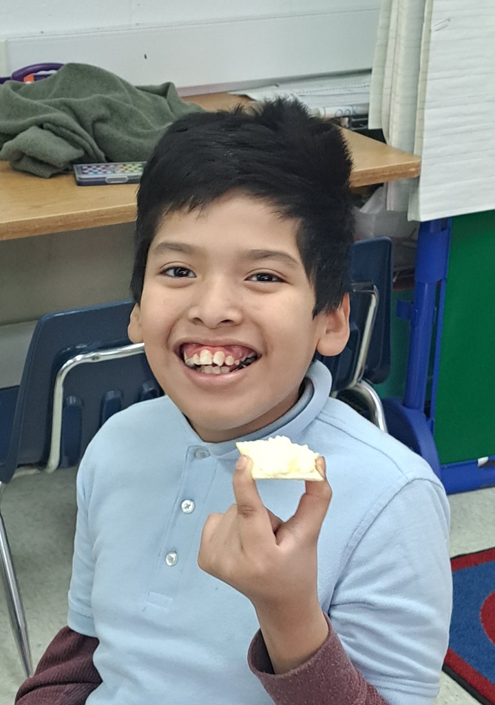Student holding cracker with butter