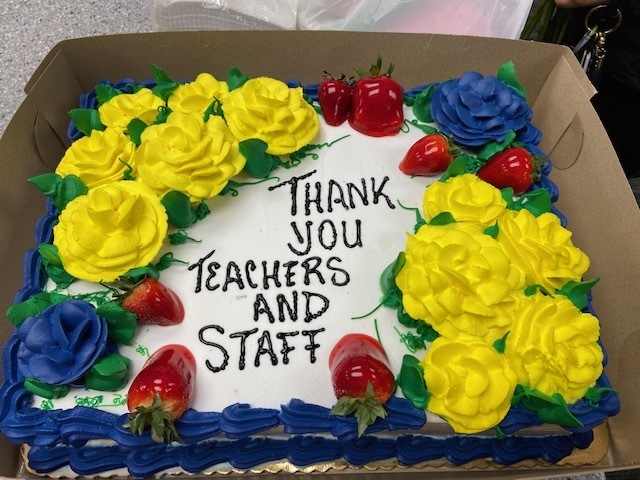 Cake with yellow and blue flowers and strawberries saying thank you teachers and staff