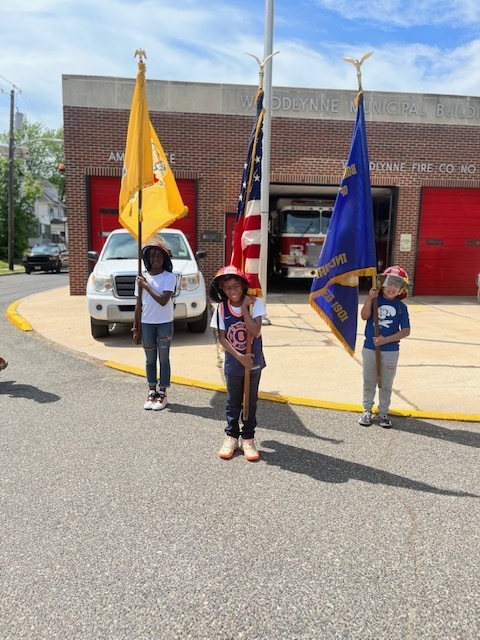 3 children holding a flag
