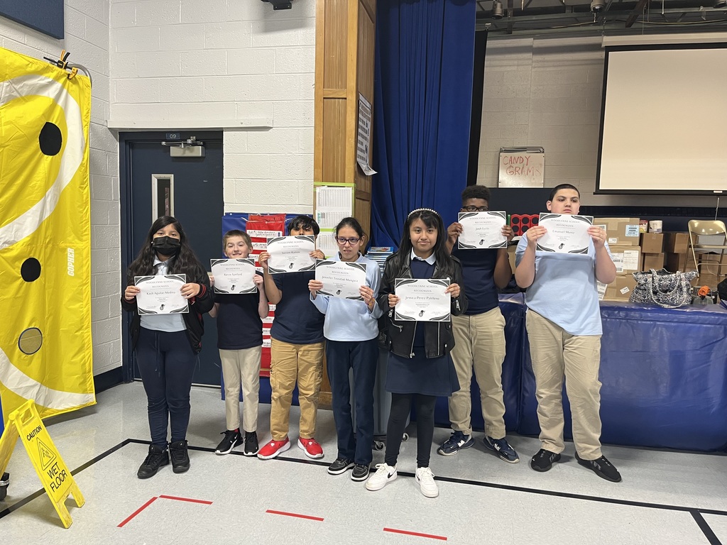 Students holding up certificates for honor roll