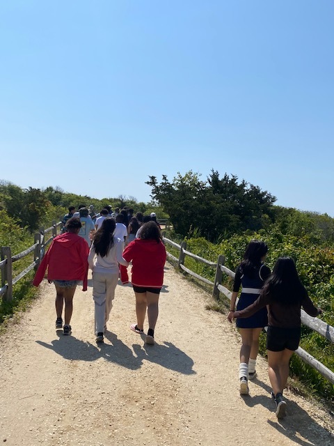 Students walking on the path to the beach at the Wetlands Institute