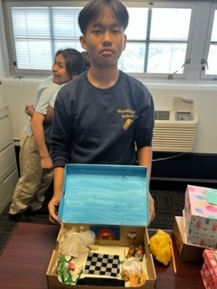 Student holding diorama box