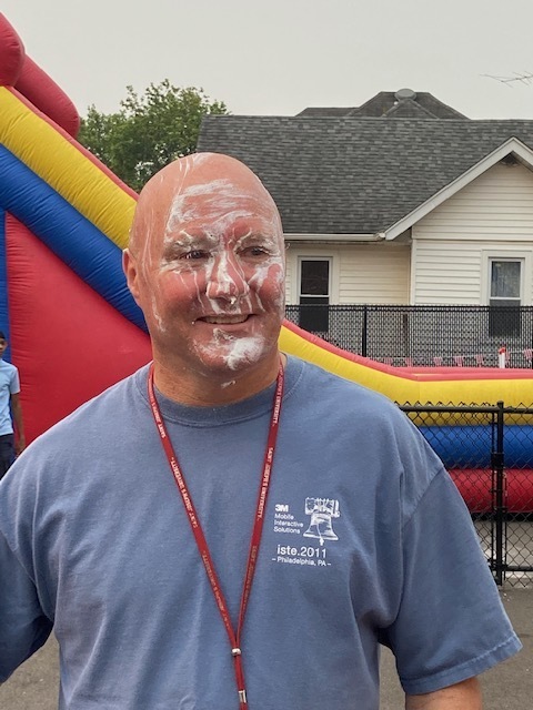 teacher with whipped cream on his face