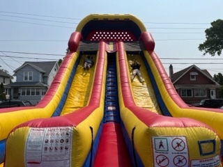 Students coming down blow up slide