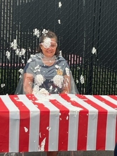 Superintendent getting pied in face